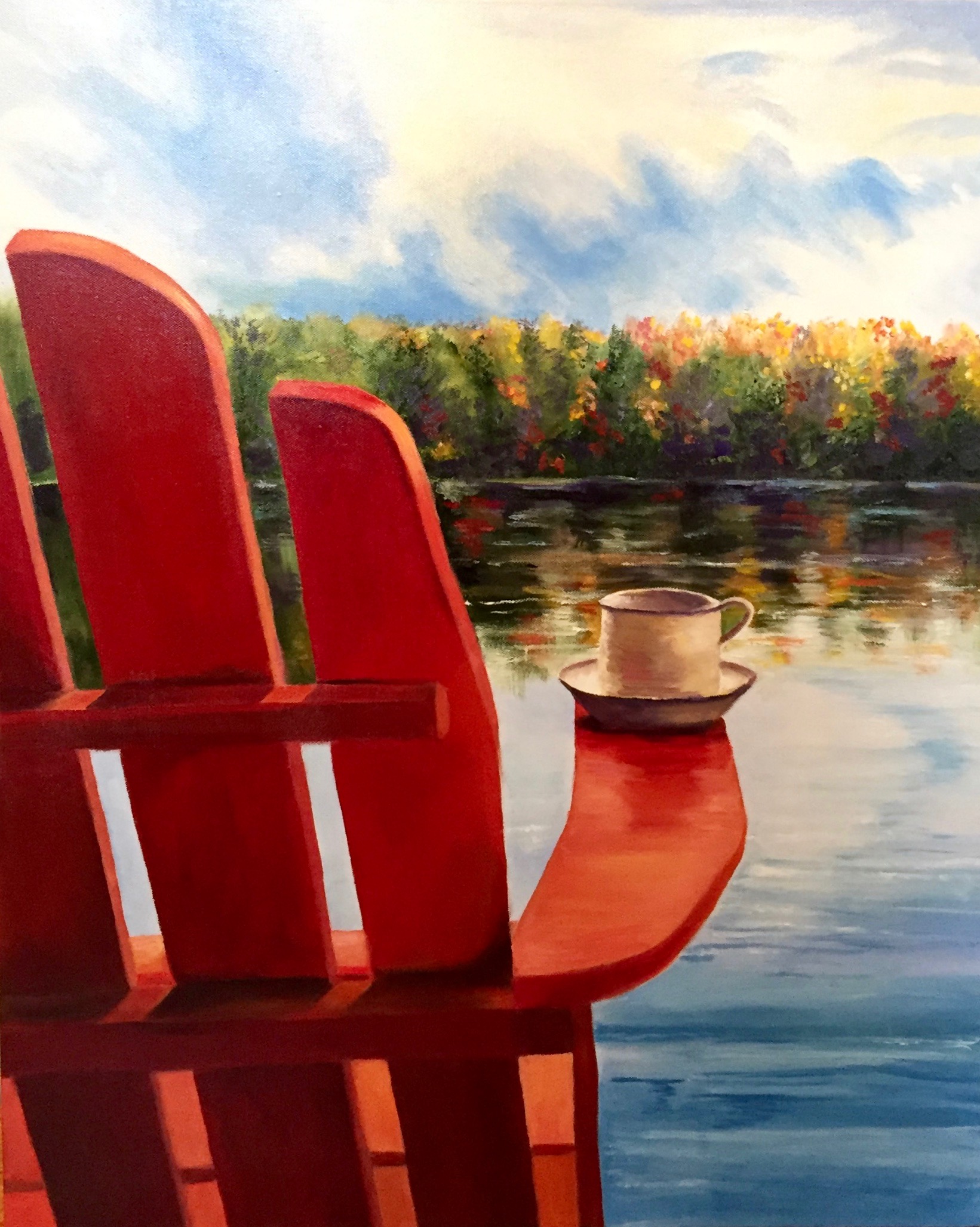 Adirondack chair facing the water, with a cup balanced on its arm.